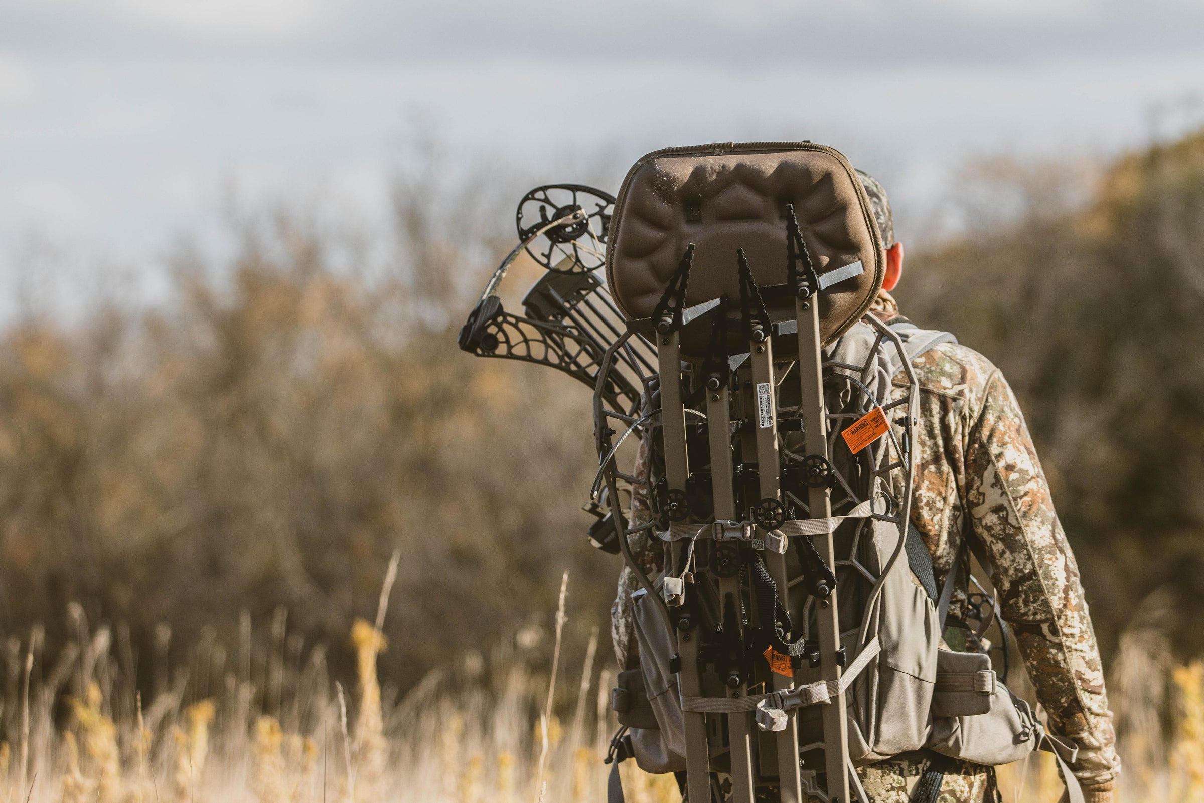 Hunter carrying a Helo Hunt Ready System into the woods